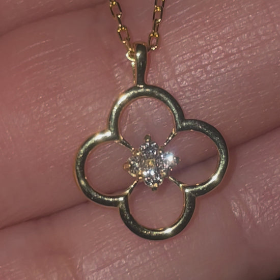 gold necklace with floral design and diamonds