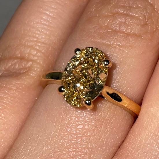 A 2ct oval-cut fancy vivid yellow diamond ring set in a solitaire 18k yellow gold band